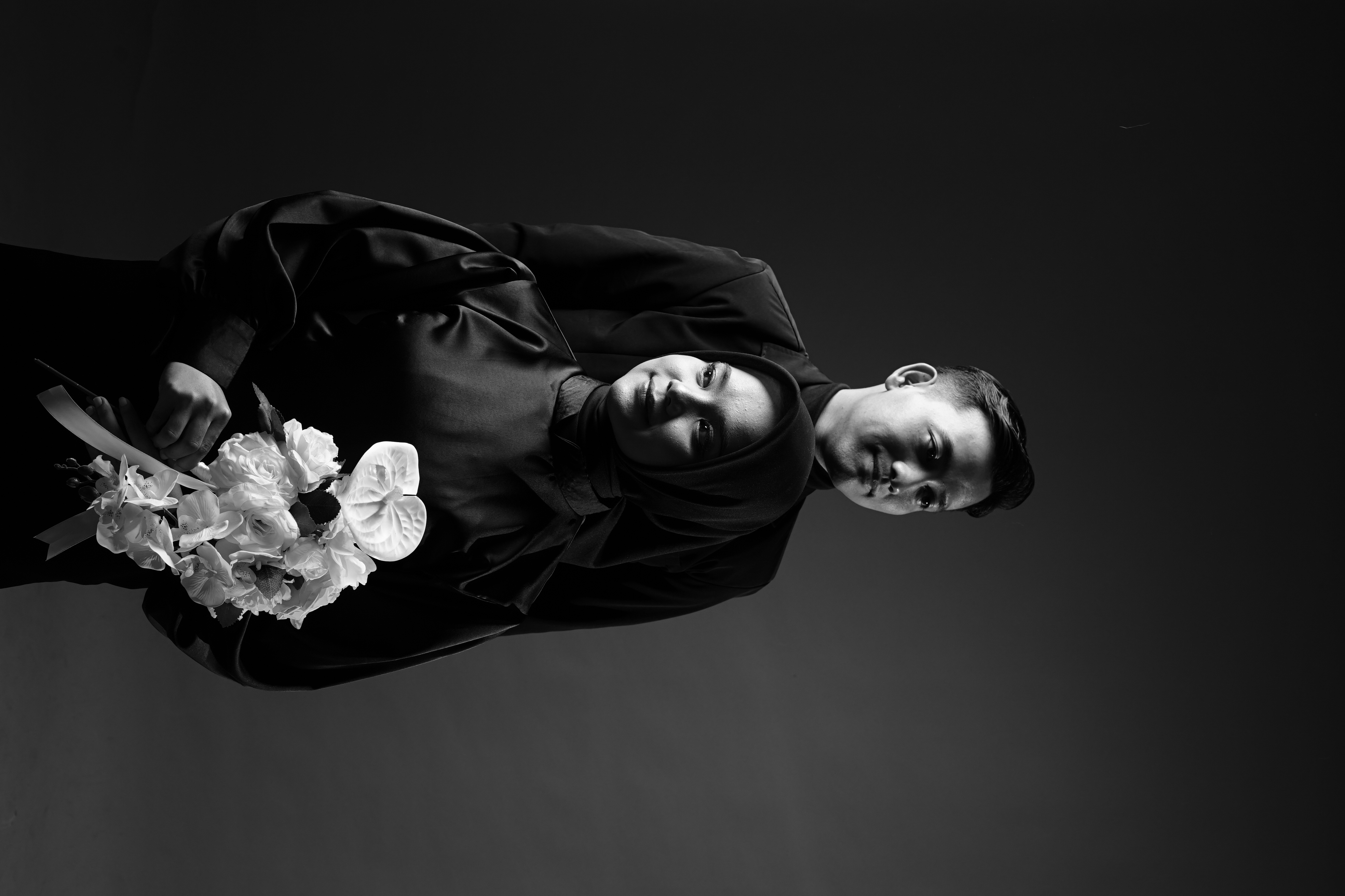 Couple posing together at sunset beach with golden light