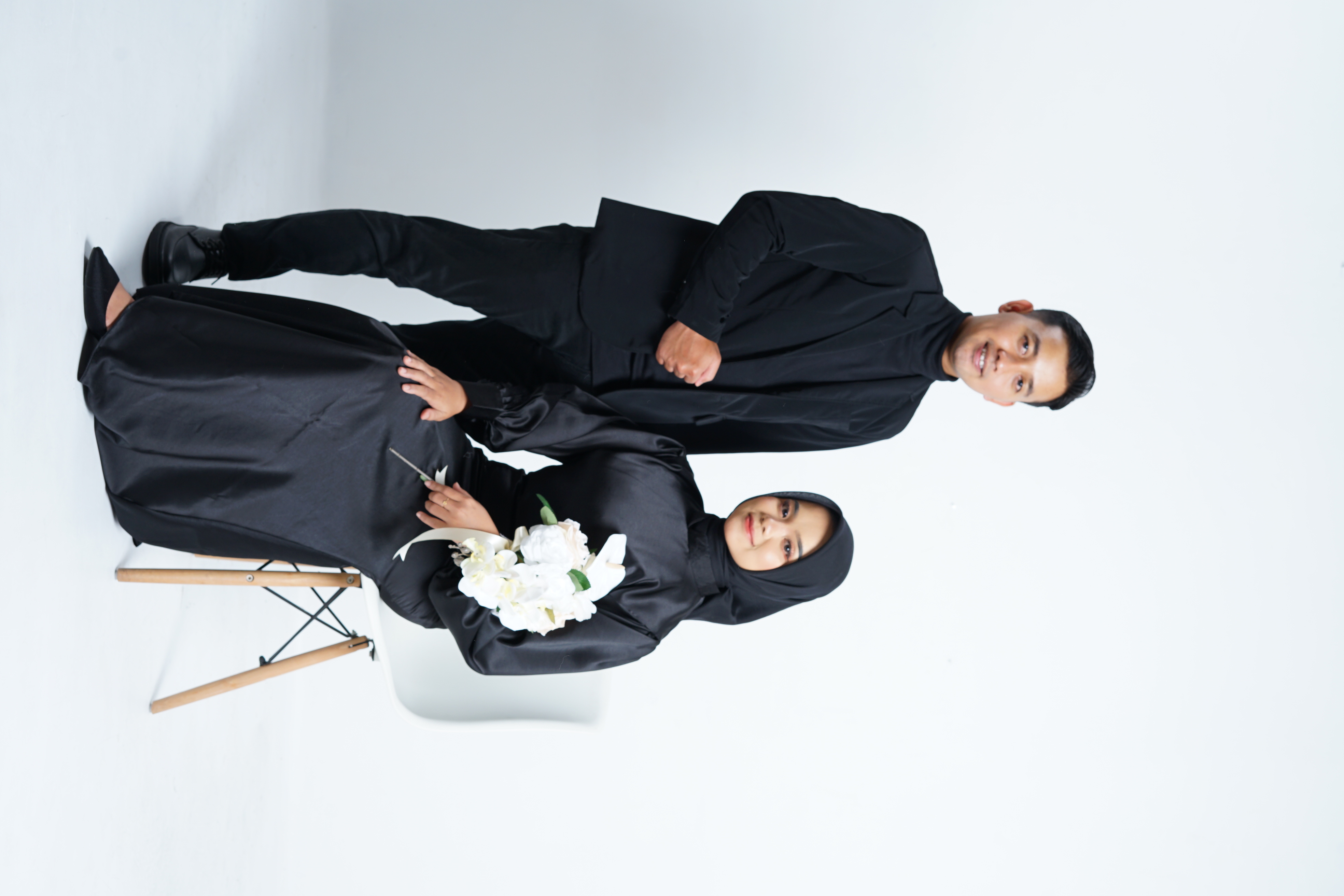 Couple trying wedding outfits together in boutique